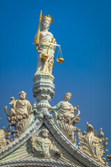 Fototapeta na wymiar St Mark Basilica, lady justice and catholic statues, facade detail, Venice