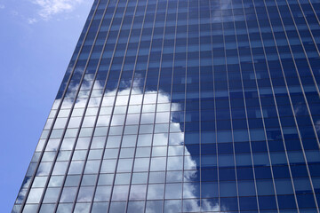 Reflection of blue sky and cloud on glass building