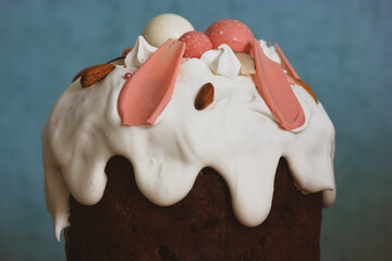 Easter cake with white icing flowing down decorative pink chocolate balls, bizet