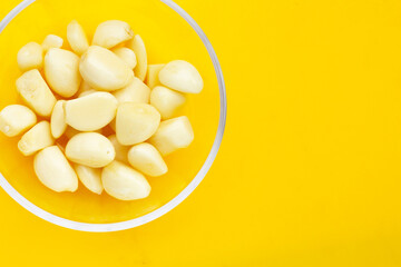 Fresh garlic on yellow background