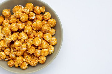 Honey caramel popcorn on white background.