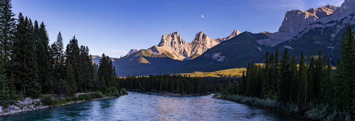 Rocky Mountain landscape with field in foreground at dusk in Canmore, Canada.
