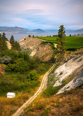 Penticton view of lake, mountains and cliffs with vineyards.