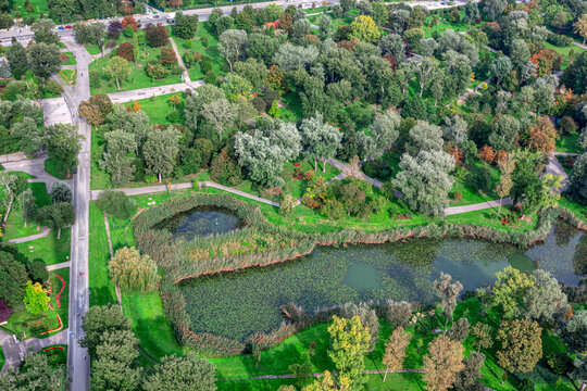 City Park And Lake With From Above . Aerial View Of Green Public Park 