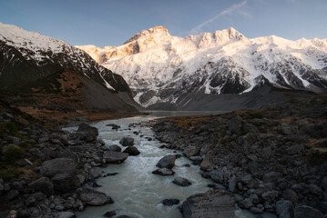 Fototapeta na wymiar The Hooker River leads the way to Mueller Lake and with Mount Sefton above catching the rising morning sunlight.