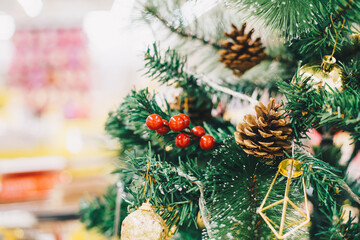 Christmas tree branch with ball and gift ornament on pine tree