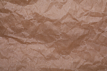 Fototapeta premium Texture of crumpled brown baking paper as background, top view