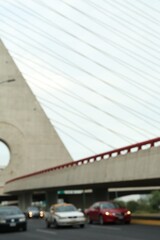 Blurred view of cars on modern bridge