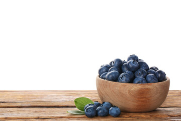 Bowl with tasty fresh blueberries on wooden table against white background