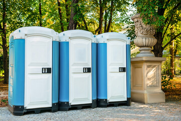 Public toilet cabins on street near trees