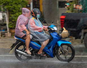 Fototapeta na wymiar Mototaxi is driving with a passenger in heavy rain