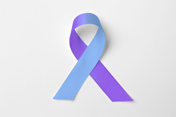 World Arthritis Day. Blue and purple awareness ribbon on white background, top view