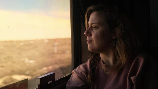Daydreaming on the Train, Blonde Woman on Train Observes the Sights Passing By
