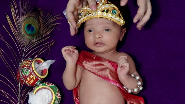 newborn baby boy in krishna dressed with props from unique perspective in different expression