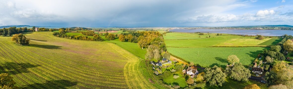 The Belvedere Tower over Powderham Park from a drone in Autumn Colors, Powderham Castle, Exeter, Devon, England