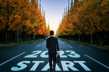 The 2023 New Year journey and future vision concept . Businessman traveling on highway road leading...