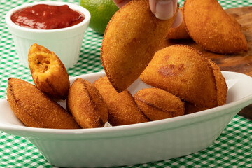 Brazilian appetizer known as chicken risoles. Selective focus.