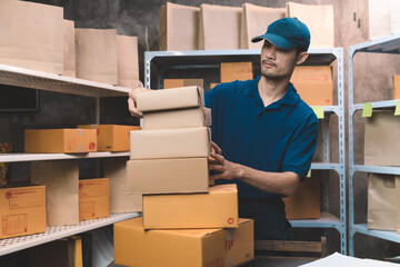 deliveryman sorting customer package prepare for transport and shipping to customer home. man doing work at his small shipping new business and new transportation delivery.