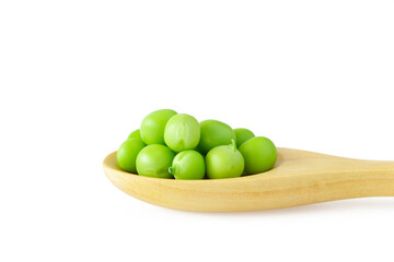 Green peas in wooden spoon isolated on white background.
