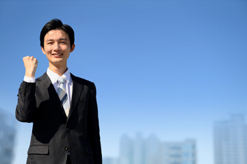 A businessman in a suit looking at the camera and posing with guts.