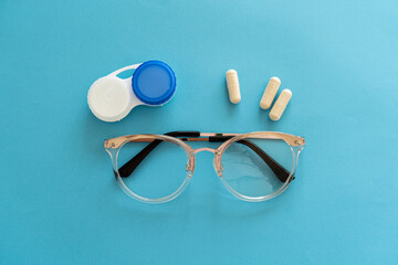 Treating vision problems. Ophthalmologist accessories for improving vision, tablets and vitamins,...