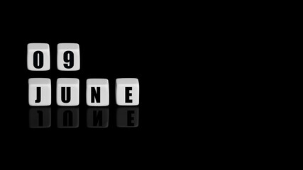 June 9th. Day 9 of month, Calendar date. White cubes with text on black background with reflection....