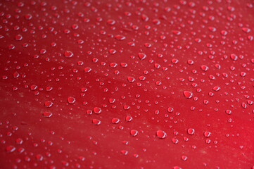 water on red hood car, transportation background