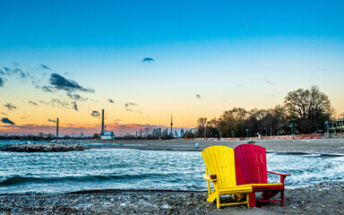 Two colorful beach chairs  on Toronto's Kew Beach. just after sunrise on a frigid winter morning...