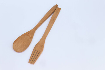 Isolated wooden spoon and fork on white background