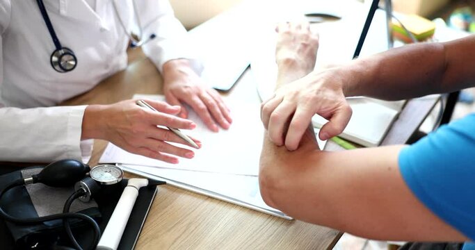 Dermatologist x examines skin of hands of sick patient with scabies and itching