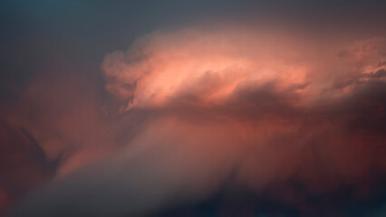 Dramatic pink and blue rain cloud background. Stormy sunset horizontal banner.