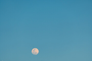 Full moon in the blue sky