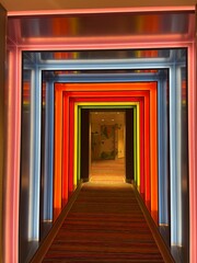Rainbow door. Multi coloured light up tunnel corridor through to mystery door