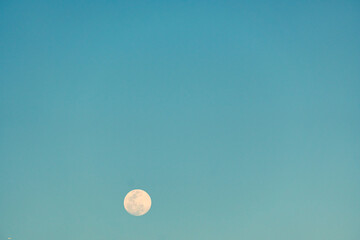 Full moon in the blue sky
