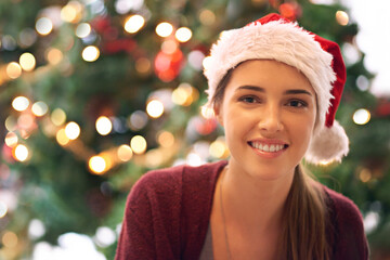 Christmas, woman and happy holiday portrait with cheerful smile at festive tree in home. Christmas...