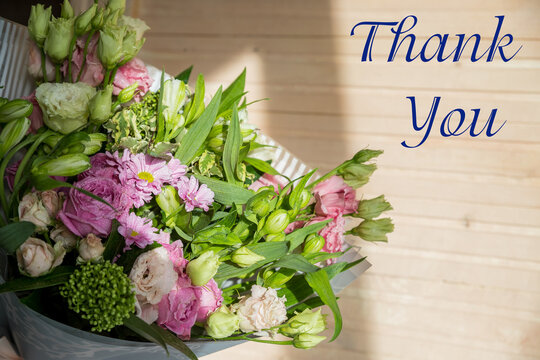 Bouquet with pink rose and lettering thank you, english. bright bouquet of roses, Lisianthus, Alstroemeria and other flowers.Present for springtime holidays.Administrative professional day concept.