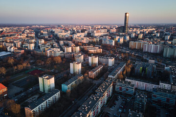 Fototapeta premium Modern residential complex in Wroclaw city, Poland. Aerial view of district with modern residence buildings, courtyards and parked cars.