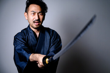 Image of a cool Japanese samurai with a sword © kapinon