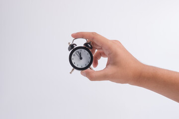 The hand of  businessman man holds the alarm clock. The Concept of Time to work,punctual on time or late.