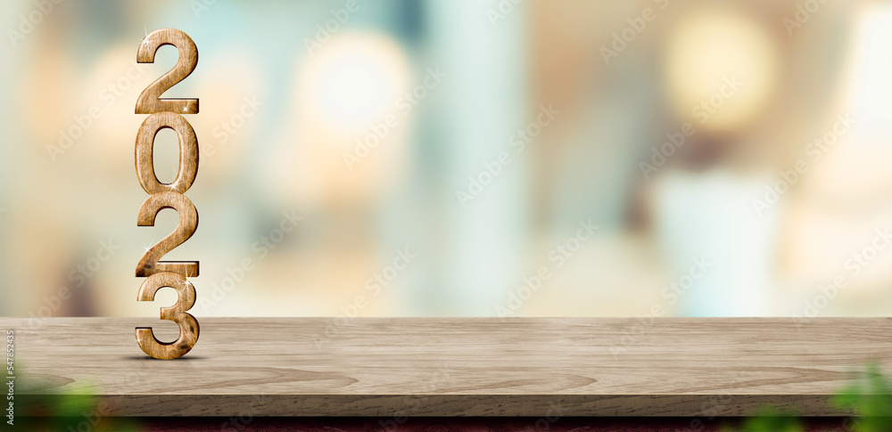 Aufkleber new year 2023 (3d rendering) on brown wood table at blur abstract bokeh light home background with b