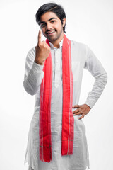 Young indian farmer giving expression on white background.