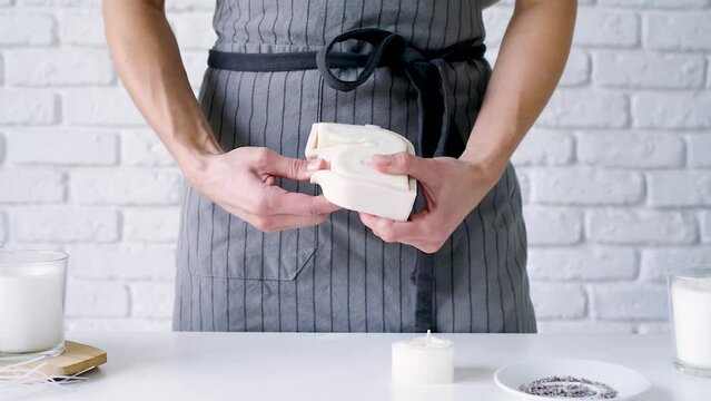 Creative occupation of candle making. Woman using silicon molds taking ready candles out