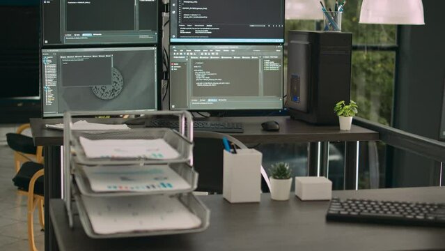 Computer monitors showing parsing code in empty it agency office, security system compiling data algorithms in background. Artificial intelligence servers cloud computing in data room.