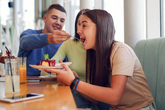 Young people having fun together at cafeteria on brunch time