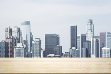 Blank wooden tabletop with beautiful Los Angeles skyline at daytime on background, mockup