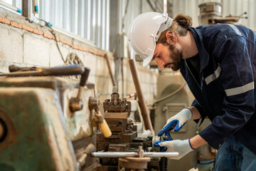 Team of engineers practicing maintenance Taking care and practicing maintenance of old machines in the factory so that they can be used continuously.