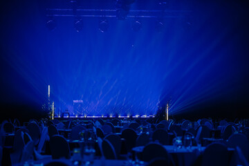 Blue light rays from the spotlight through the smoke at the theater or concert hall. Lighting...