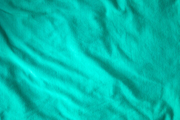 Fototapeta na wymiar Fine green Textile with Ripples and Folds light Banner