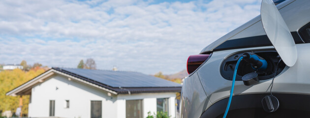 Charging an electric car in home,sustainable transportation concept.