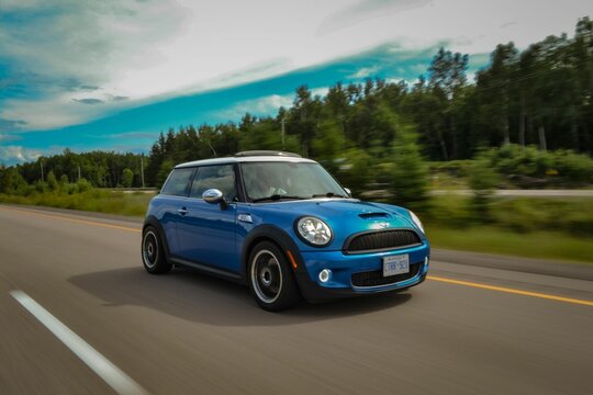 Blue mini cooper on road during drive